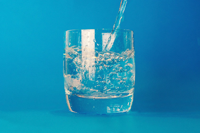 glass of water blue background